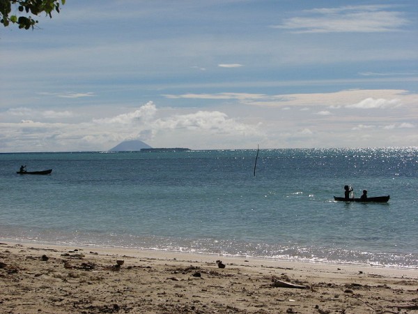 Looking towards the Great Reef from Fenualoa, Reef Islands, Solomon Islands. Active volcano Tinakula across the waters. Photo by Pohopetch.